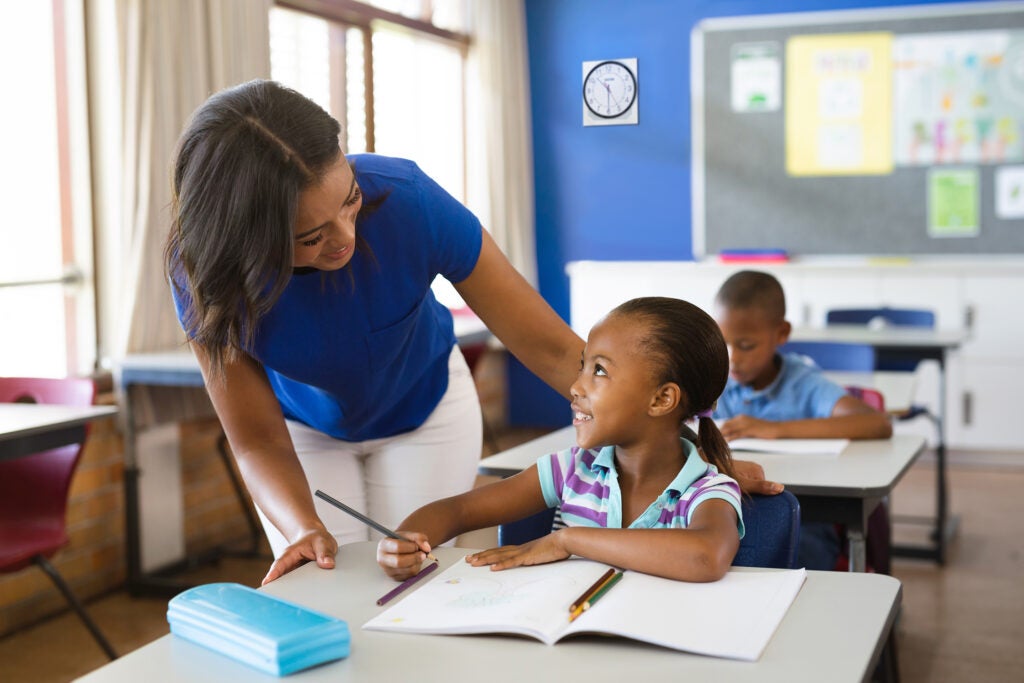 Teacher with student in classroom setting